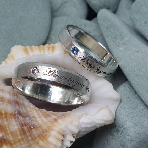 Two silver rings with inscriptions on a seashell. 2