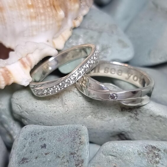Two rings with inscriptions on a rocky surface with seashells. 5