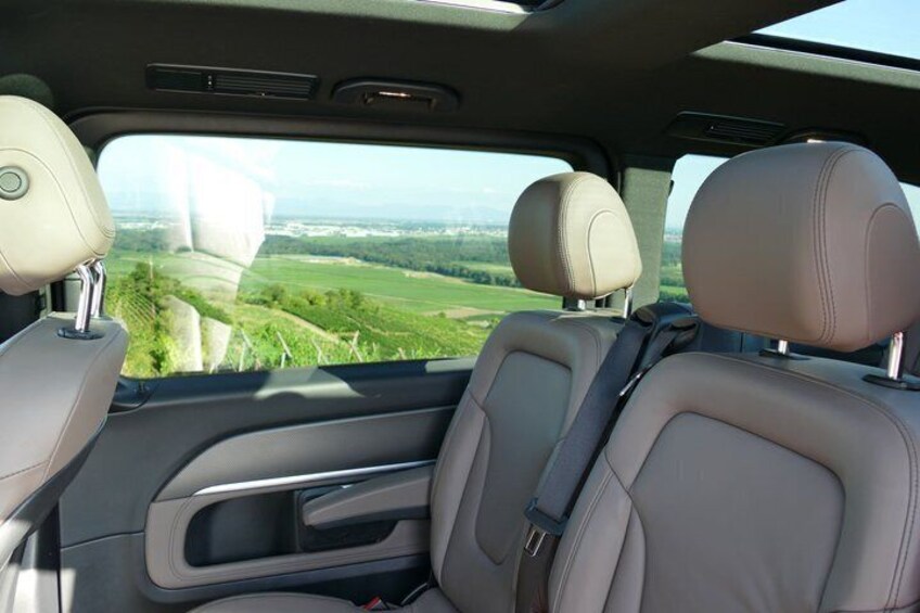 A car's interior with leather seats and a sunroof. 3