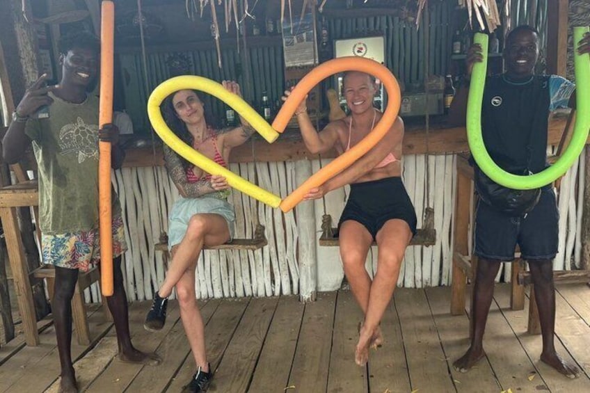 A wooden deck with people holding hula hoops. 4