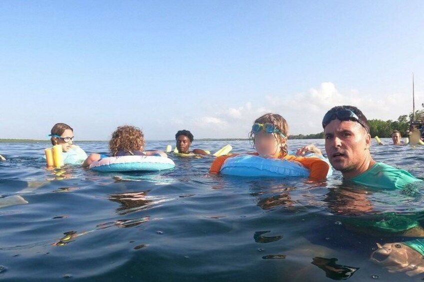 People floating on water with life vests. 3