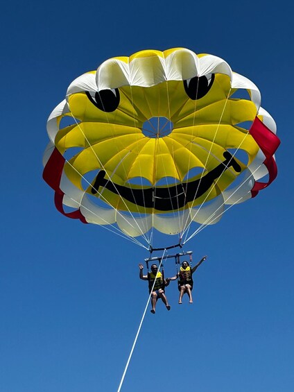Two people skydiving with a parachute. 1