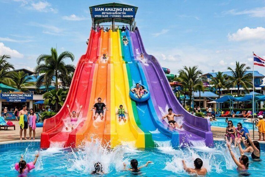 A water park with a multi-colored slide and a pool area. 3
