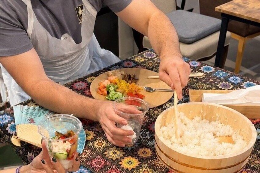 A person preparing a meal with vegetables and rice. 3