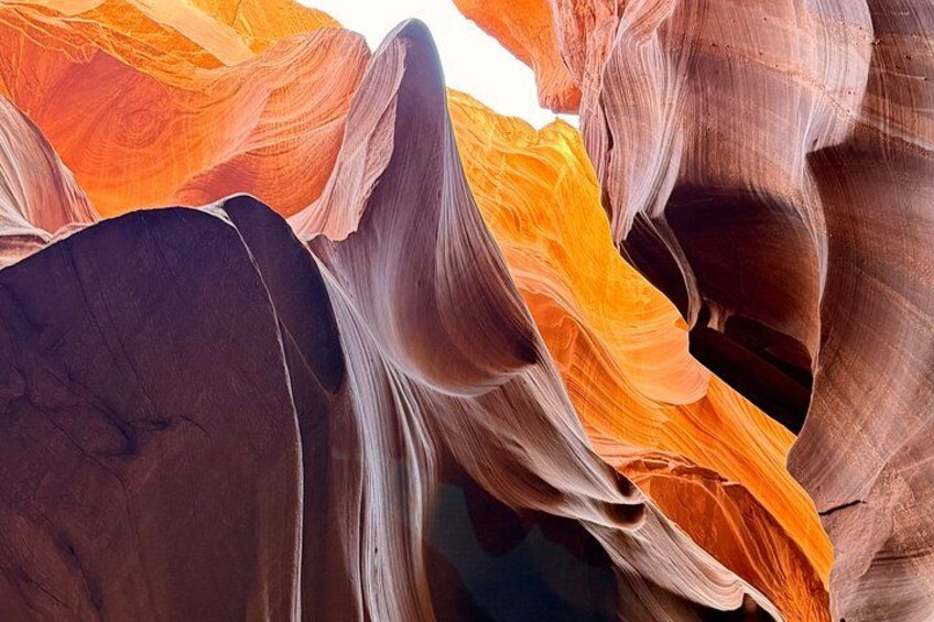 A close-up of colorful rock formations with smooth, flowing curves. 3