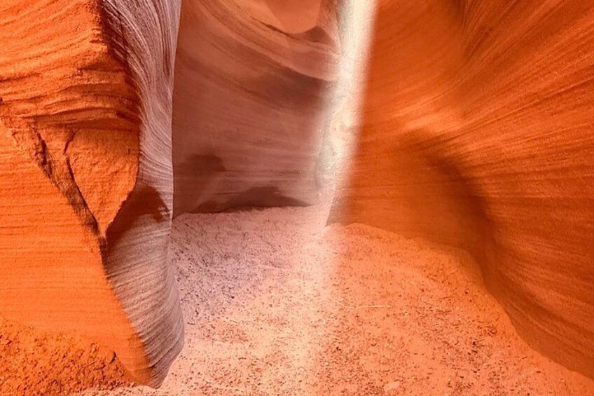 A narrow canyon with smooth, curved rock walls and a narrow passageway. 5