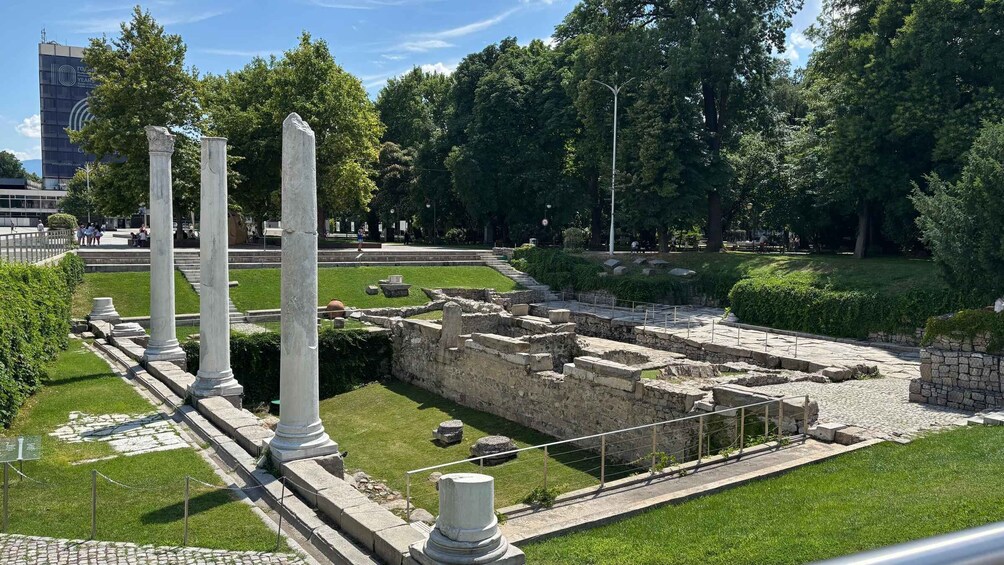 Ancient ruins with columns and stone structures. 1