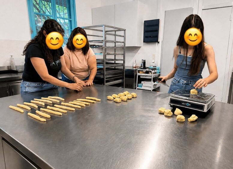 Three people in a kitchen preparing dough. 5