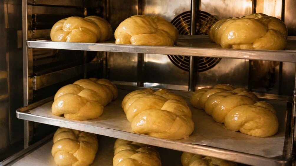 A bakery with multiple shelves displaying freshly baked bread. 1