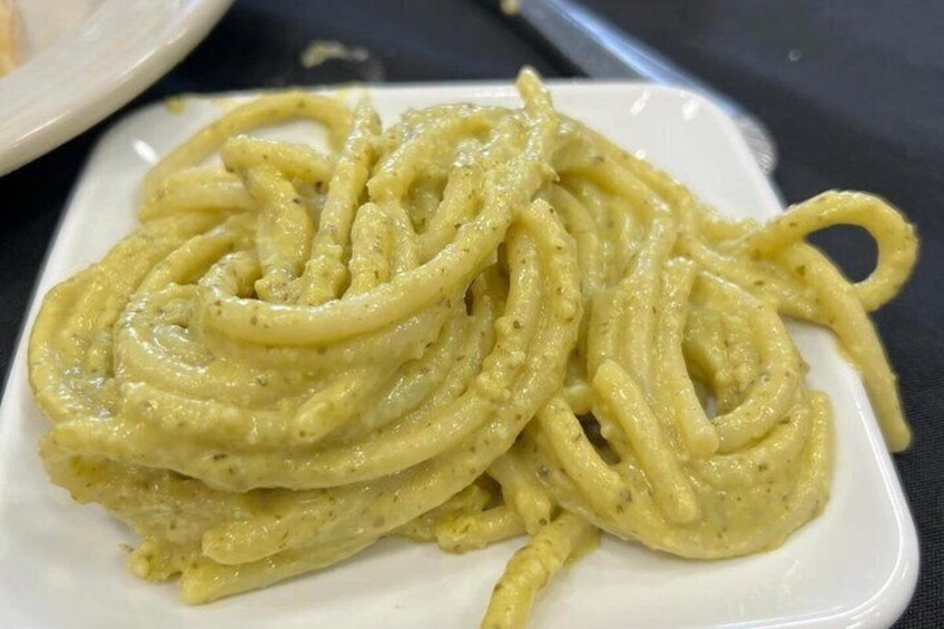 A plate of spaghetti with a creamy sauce. 4