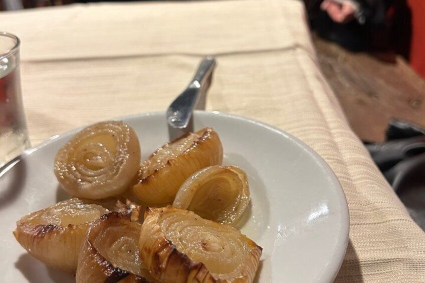 A plate of caramelized onions on a white plate with a spoon. 5