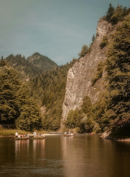 A river with boats and people on the shore. 5
