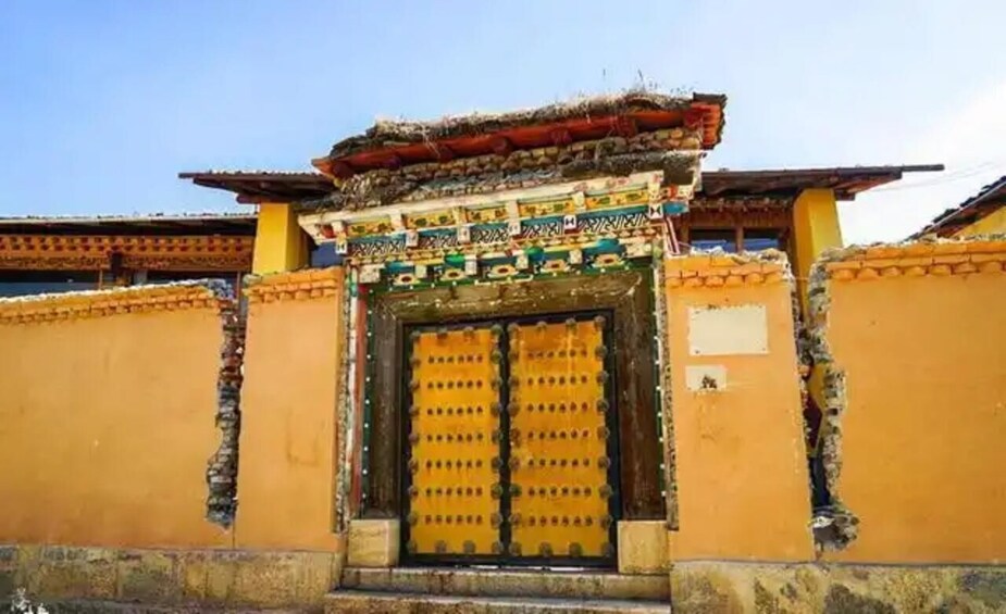 A traditional building with a colorful facade and a large central door. 5