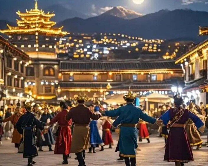 A traditional dance performance in a historic town square with illuminated buildings and a prominent pagoda in the background. 1