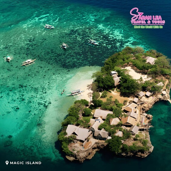 An aerial view of Magic Island with clear turquoise waters, boats, and traditional houses. 2