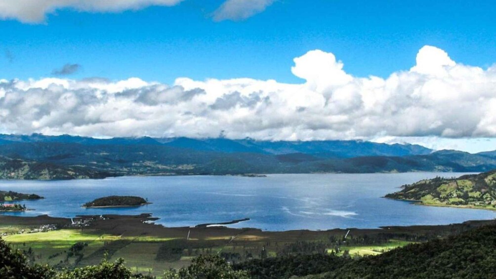 A large lake surrounded by mountains and a cloudy sky. 5