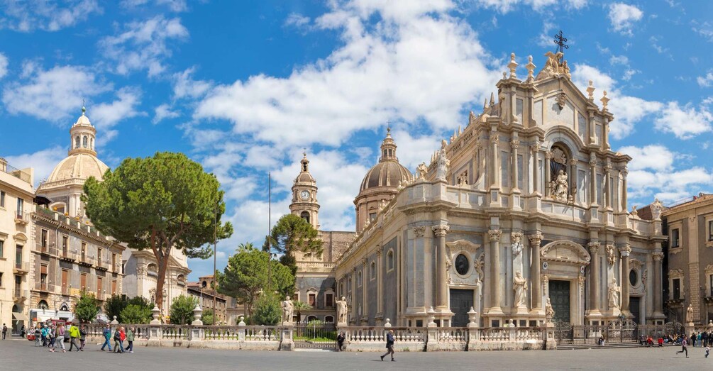 A historic plaza with ornate buildings, including a prominent church with a dome and statues. 4