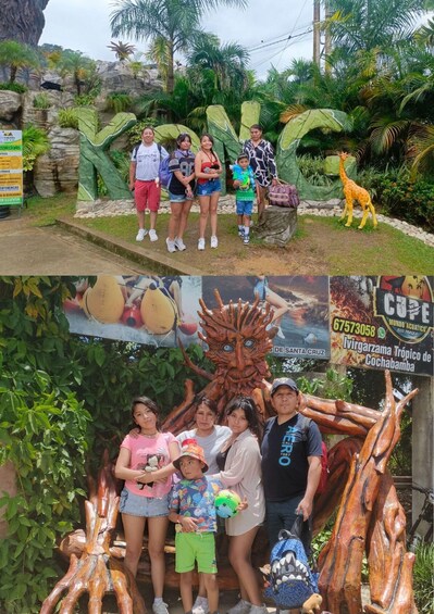 A family at a theme park with a large rock formation and a giraffe statue. 4