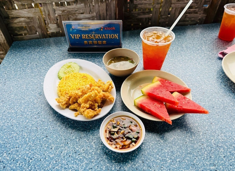 A table with food and drinks, a VIP reservation sign, and a wooden fence in the background. 4