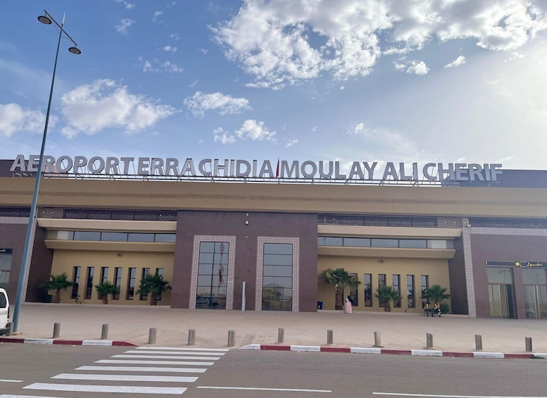 An airport terminal with a clear sky and clouds. 1