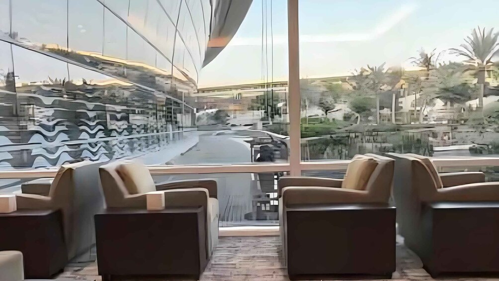 A modern outdoor seating area with chairs and a view of a road and buildings. 3
