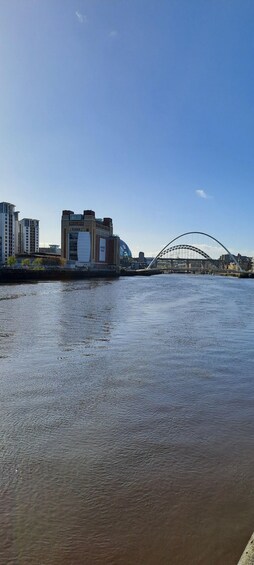 A river with a bridge and buildings in the background. 3