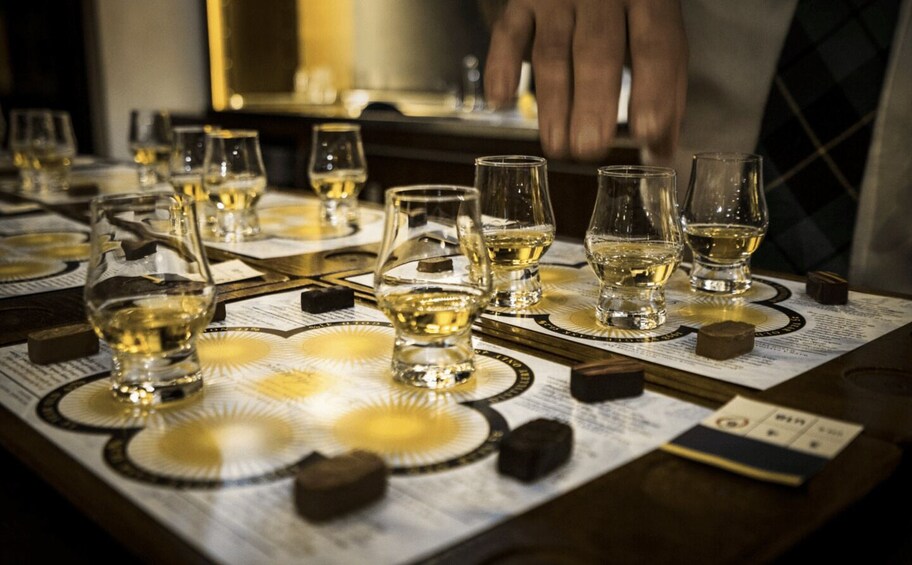 A tasting event with multiple glasses of wine on a table. 5