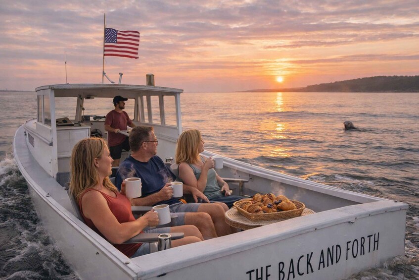 A boat with three people enjoying a sunset over the water. 1
