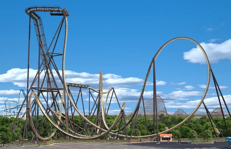 A roller coaster with multiple loops and tracks, set against a clear blue sky with scattered clouds. 4