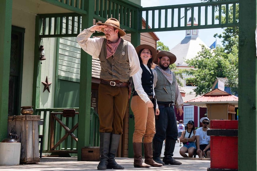 A historical reenactment scene with actors in period costumes, a wooden structure, and a town setting. 2