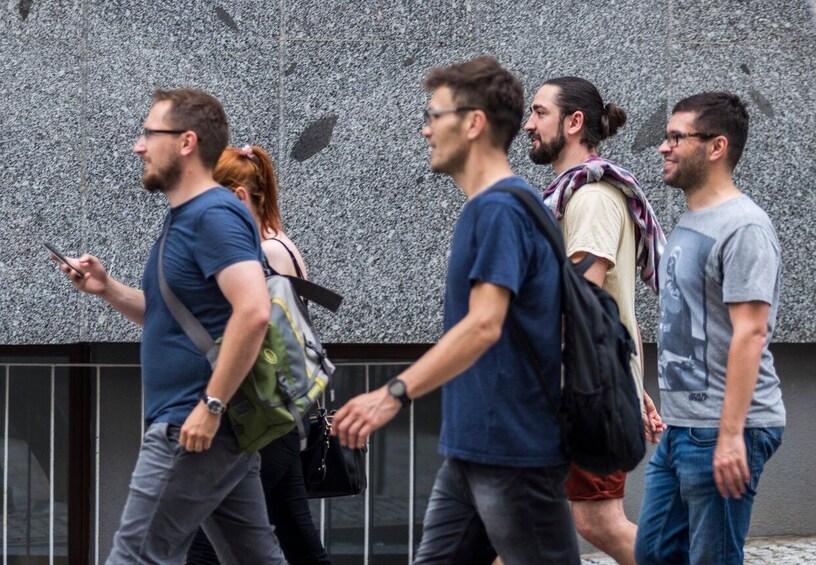 A group of people walking on a sidewalk. 3