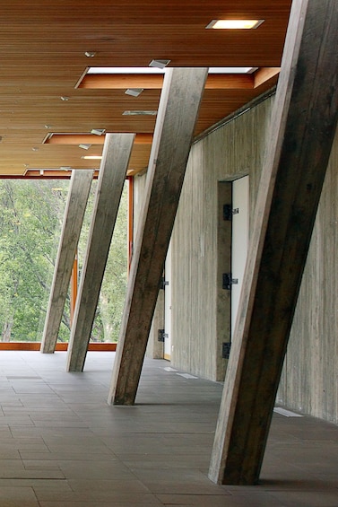 A modern architectural structure with concrete pillars and a tiled floor. 2