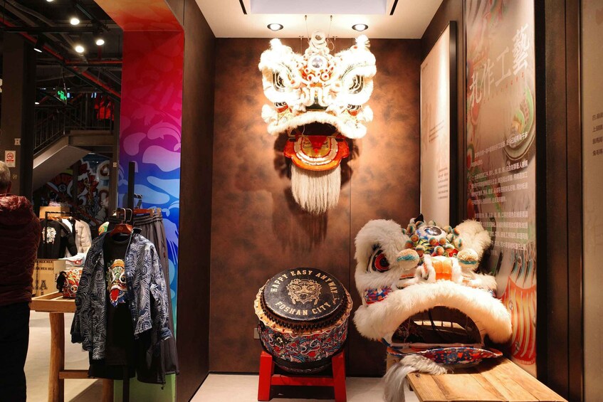 A traditional Chinese lion dance costume, a shop with colorful clothing, and a decorative drum. 3