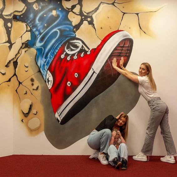 A mural of a red shoe with a white sole and black laces. 1