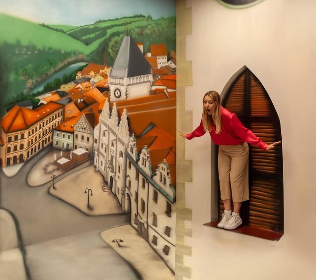 A mural of a town with buildings and a clock tower. 2