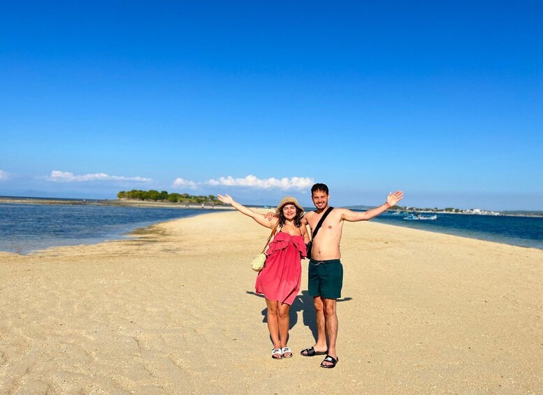A beach with a clear sky, a sandy shore, and a calm sea. 5