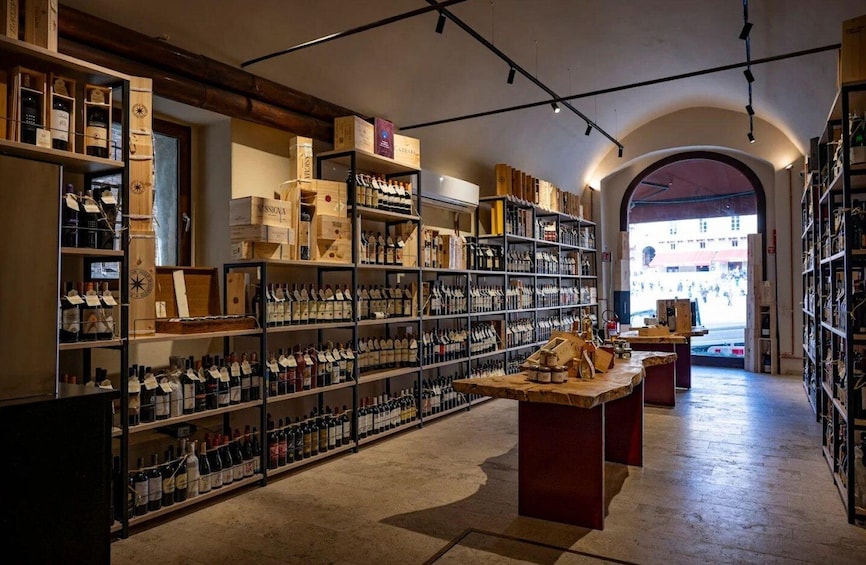A wine cellar with shelves stocked with bottles and wooden crates. 3