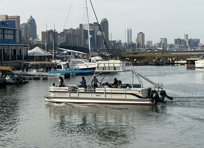 A river with boats docked, a city skyline in the background, and a bridge. 3