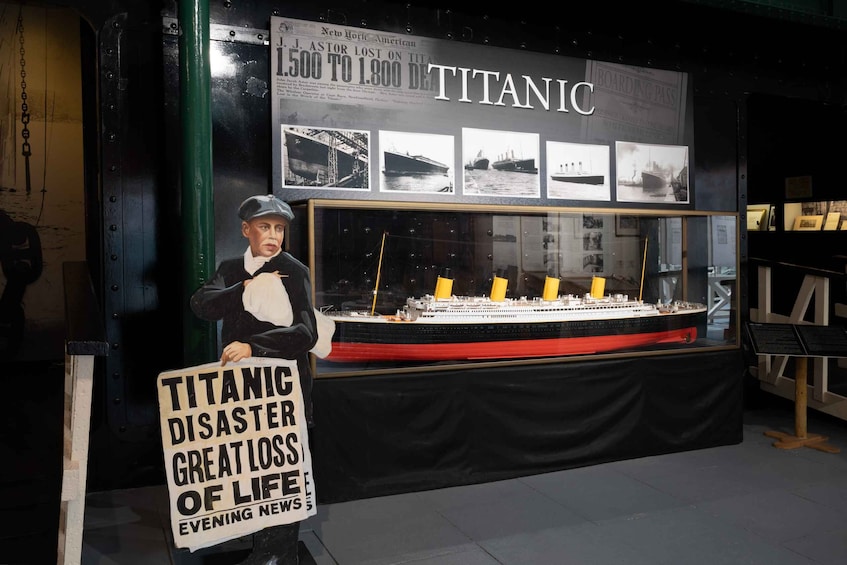 A Titanic exhibit with a model ship and historical newspaper clippings. 1