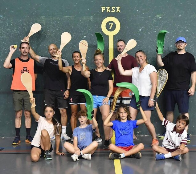 A group of people holding paddles and a green key, with the number 7 visible. 1