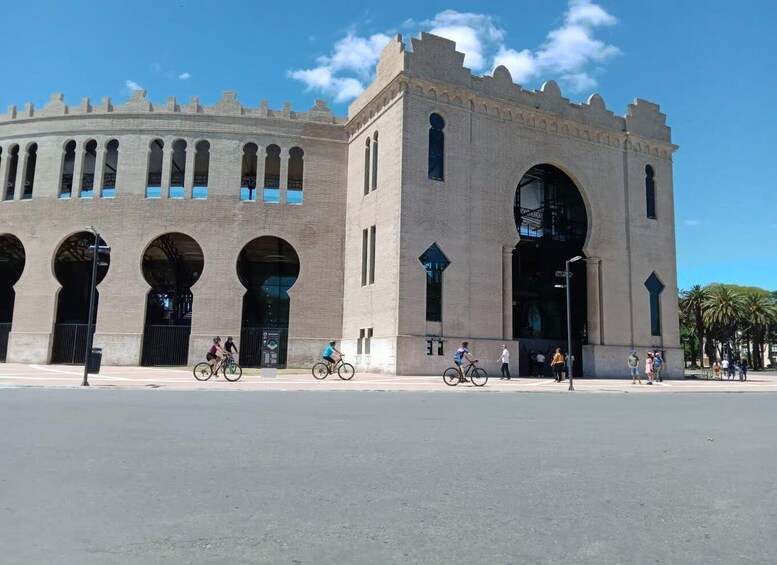 A historic building with arched windows and a large central archway. 4
