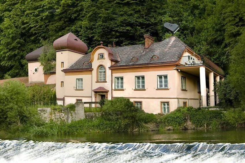 A large house with a water feature in front. 1