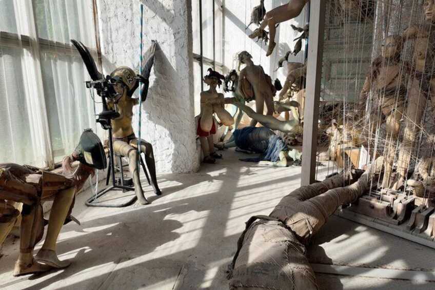 A room with various sculptures and mannequins. 2