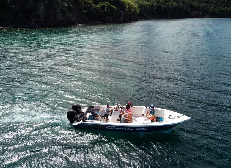 A small motorboat on calm water with people on board. 4