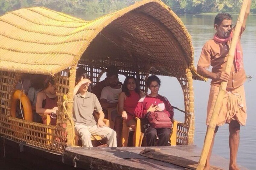 A traditional boat with passengers, a person standing at the stern, and a thatched roof. 2