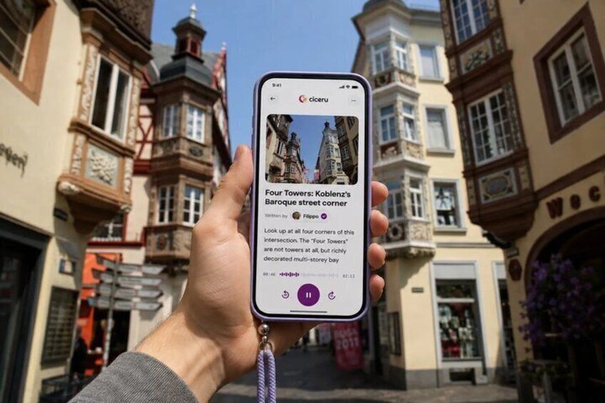 A hand holding a smartphone displaying a photo of a historic building with a caption. 1
