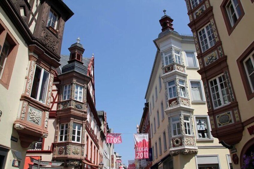 A street with traditional European architecture, including ornate facades and detailed window designs. 2