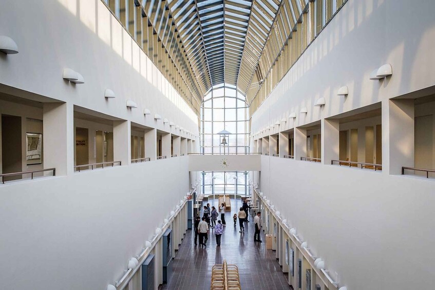 A spacious interior with a high ceiling and a central skylight. 4