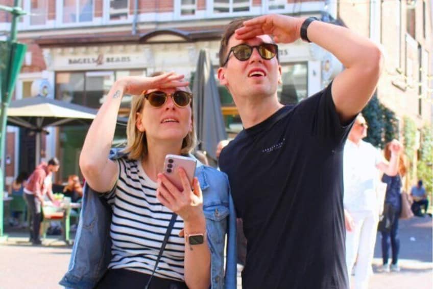 Two people taking a selfie with a building in the background. 5