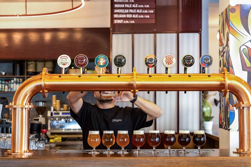 A bartender pouring beer from a tap into a glass. 5